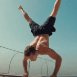 Calisthenics exercise - man performing a handstand at home with no equipment.