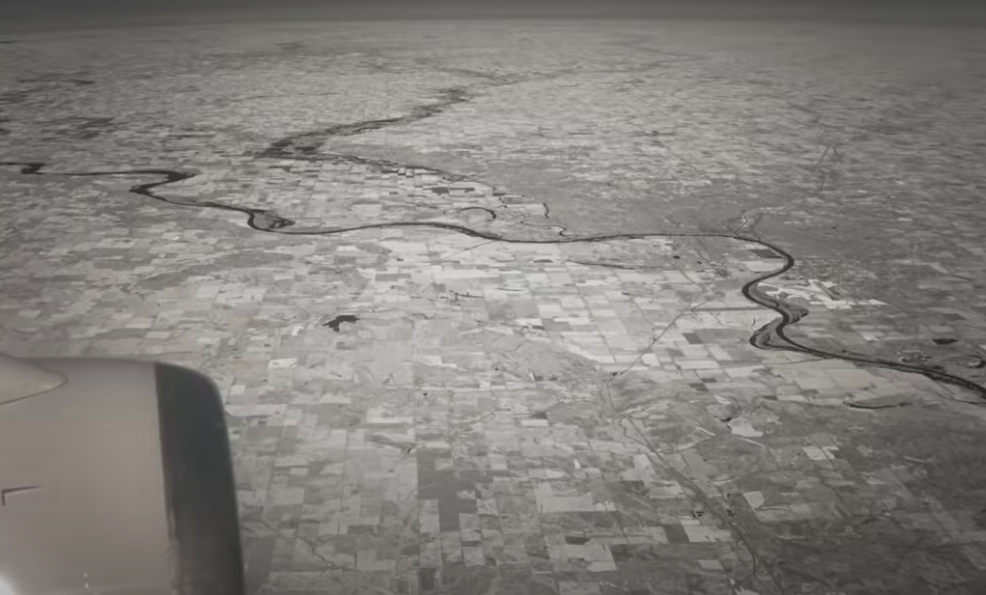 Aerial view of land with horizon appearing flat, supporting the flat Earth theory.