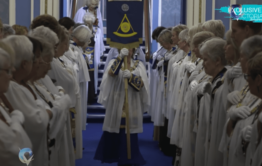 People inside a Masonic Lodge during a secret ceremony.