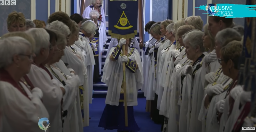 People inside a Masonic Lodge during a secret ceremony.