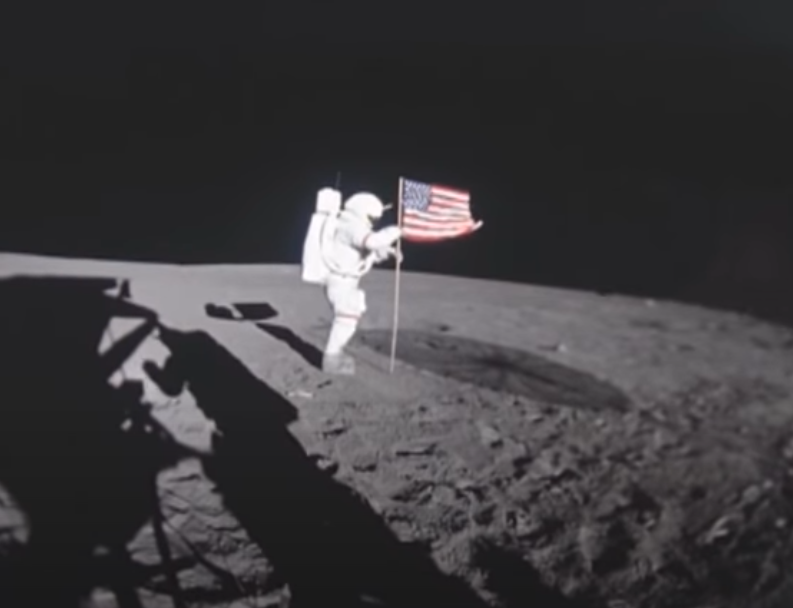 Astronaut planting American flag on the moon's surface during the Apollo 11 mission, image used in Moon Landing Hoax conspiracy theory article.