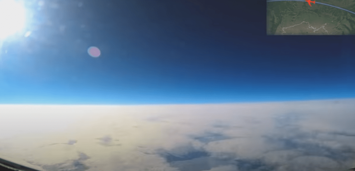 Aerial view from a plane showing a flat horizon, providing evidence that the world is not a globe