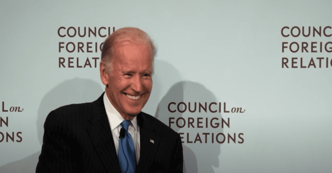 Joe Biden standing in front of the Council on Foreign Relations (CFR) logo wall.