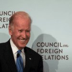 Joe Biden standing in front of the Council on Foreign Relations (CFR) logo wall.