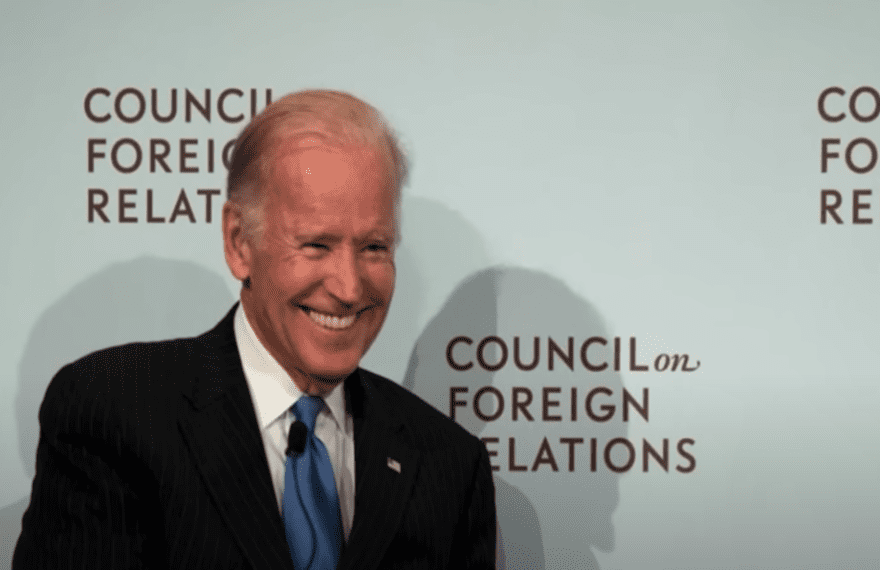 Joe Biden standing in front of the Council on Foreign Relations (CFR) logo wall.