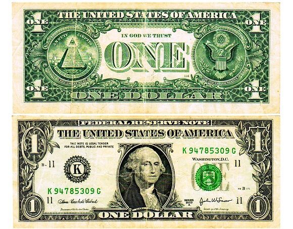 The front and back of a US one dollar bill showing mysterious symbols and hidden messages