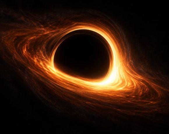 Artist illustration of a glowing orange ring surrounding a black hole shadow.