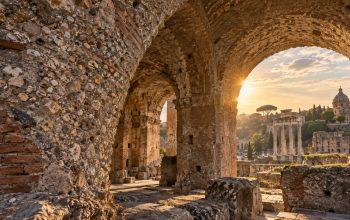 Illustration of ancient Roman concrete arches and exposed stone aggregate in warm sunlight.