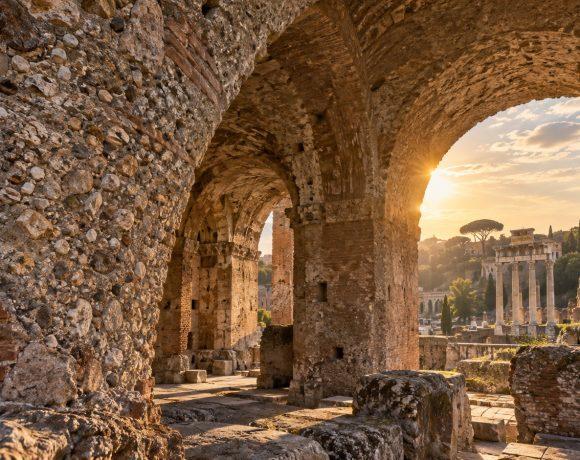 Illustration of ancient Roman concrete arches and exposed stone aggregate in warm sunlight.